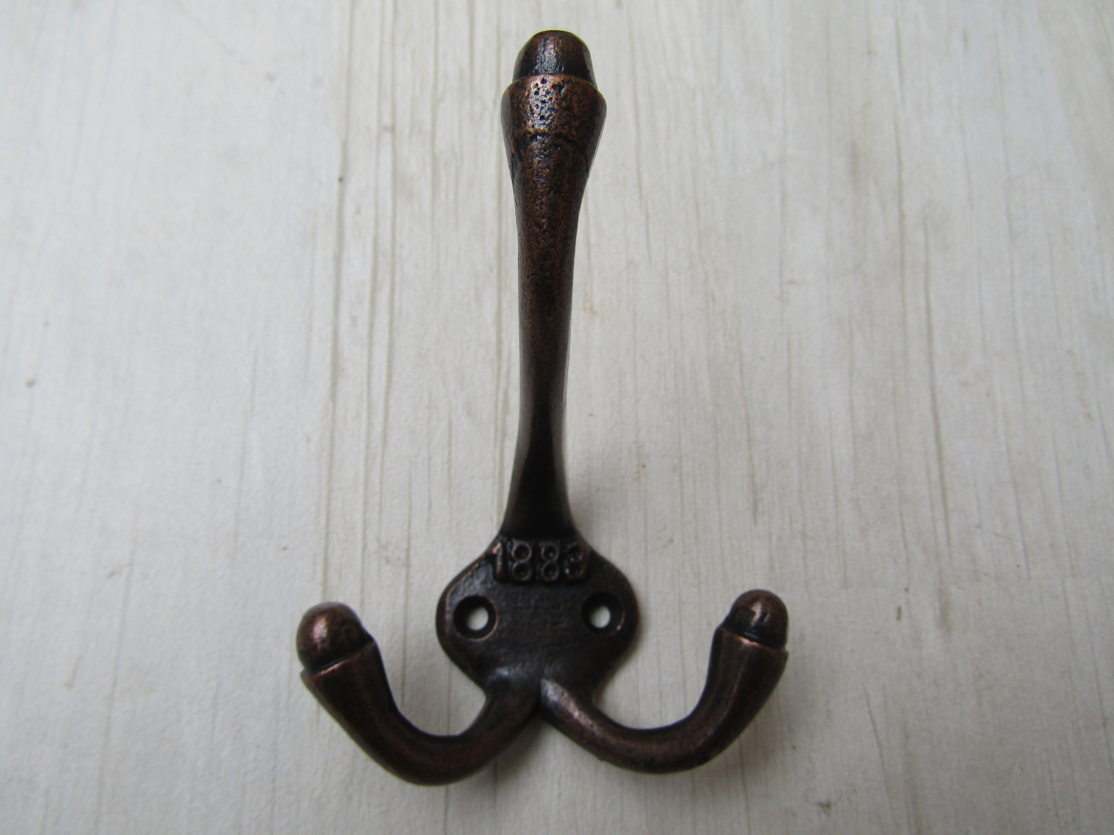 Small 1883 Embossed Coat Hook Antique Copper.