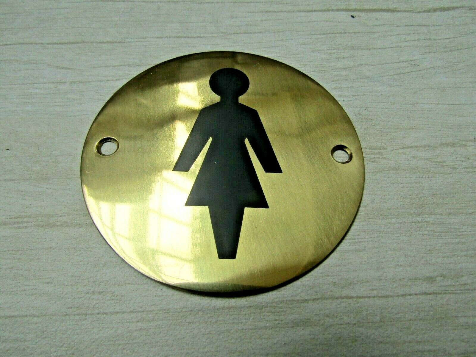 Circle Brass Female Door Sign.
