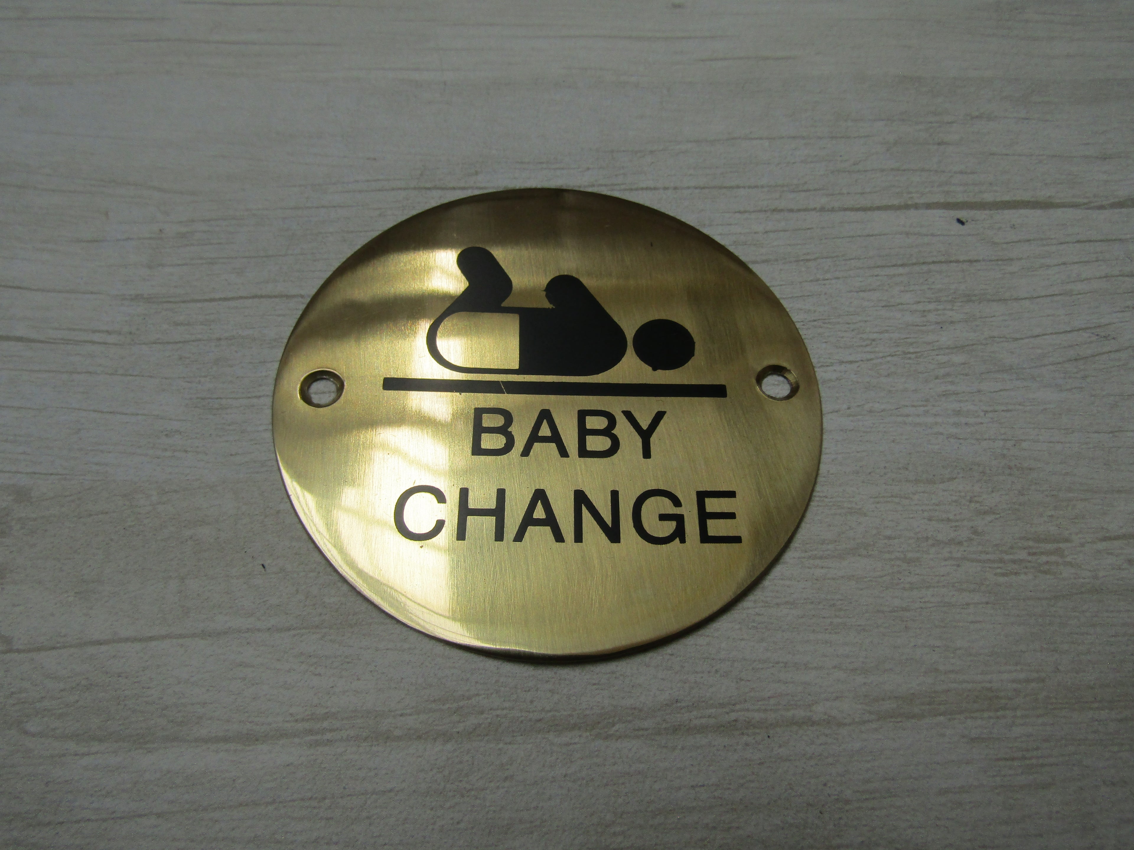 Circle Brass Baby Change Door Sign.