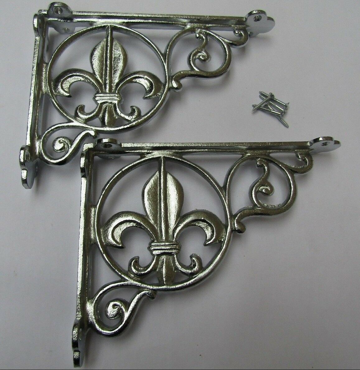 Pair Of Fleur De Lys Shelf Brackets Chrome.