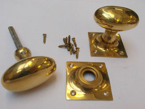 Rim door knob set Oval Square base Polished Brass.