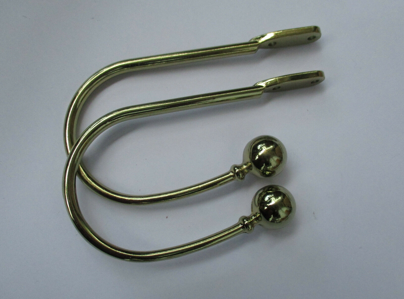 Pair of ball end Curtain hold backs Polished Brass.