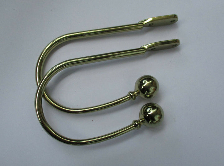 Pair of ball end Curtain hold backs Polished Brass.
